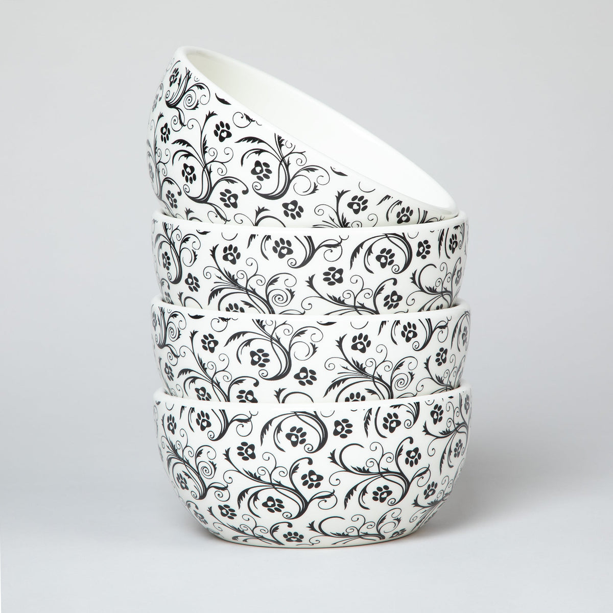 Ceramic soup bowl stack with white base and black paw-print swirl pattern