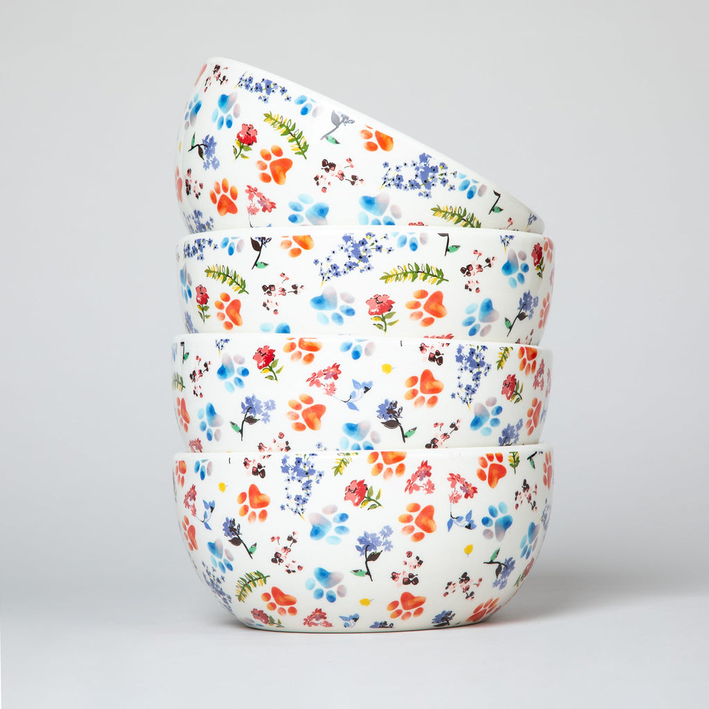 Ceramic soup bowl stack with white base and multicolor paw-print and flower pattern