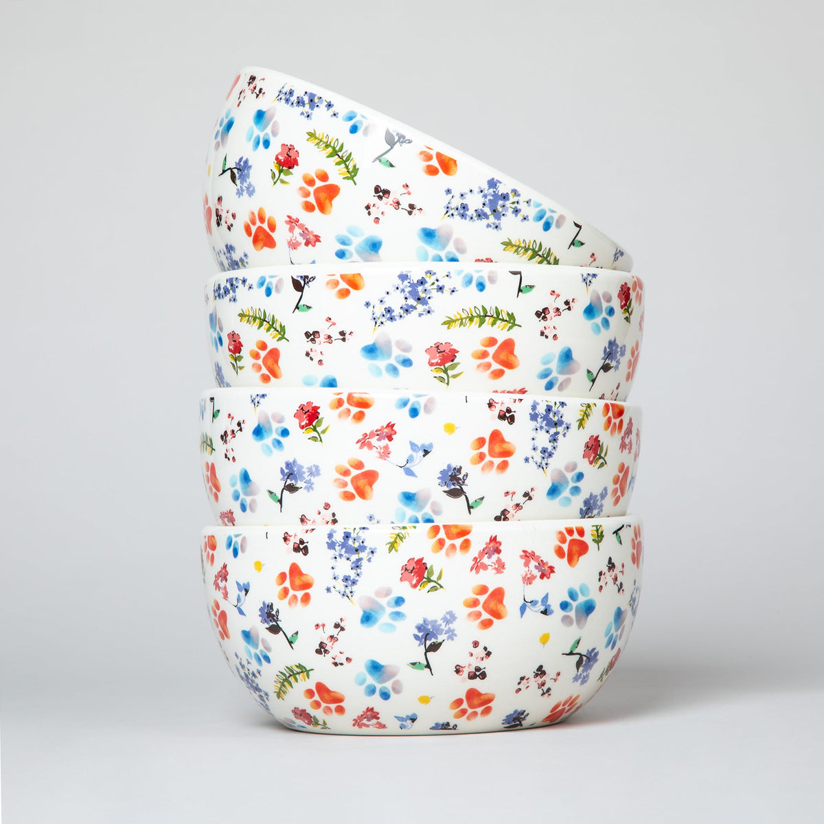 Ceramic soup bowl stack with white base and multicolor paw-print and flower pattern