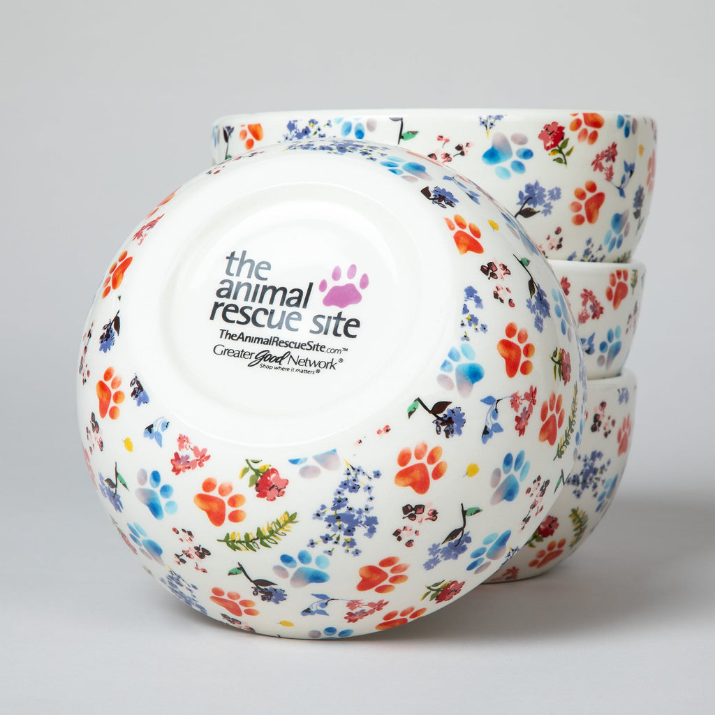 Ceramic bowl bottom with circular logo and multicolor paw-print pattern