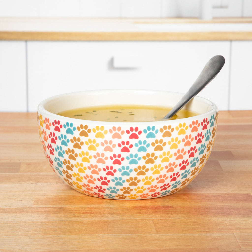 Ceramic paw-print soup bowl in pastel multicolor with spoon, white interior