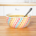 Ceramic paw-print soup bowl in pastel multicolor with spoon, white interior
