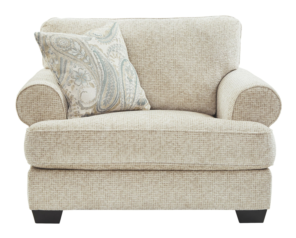 Sandstone upholstered chair with patterned lumbar pillow and cushioned armrests