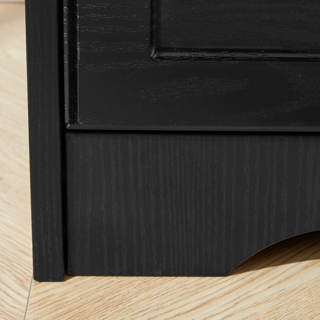 Bottom corner of black chest of drawers with sturdy cabinet leg and base panel