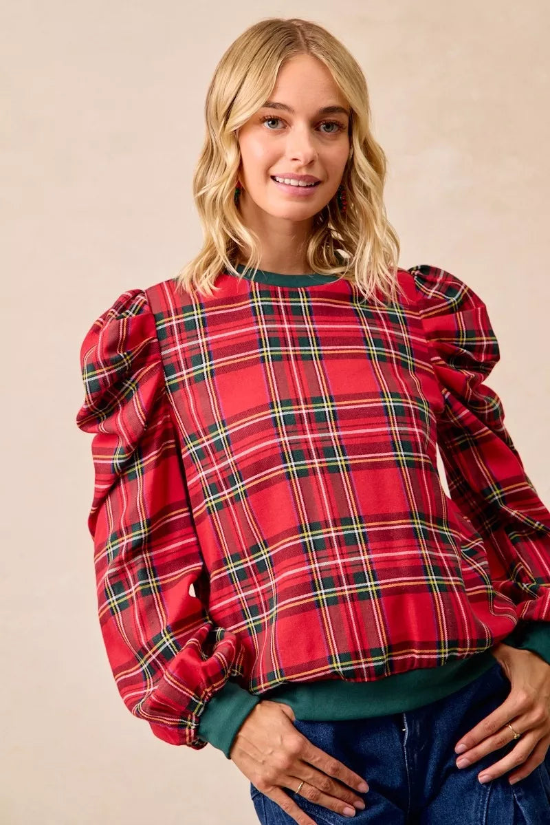 Red plaid long-sleeve top with exaggerated shoulders and green hem and cuff trim