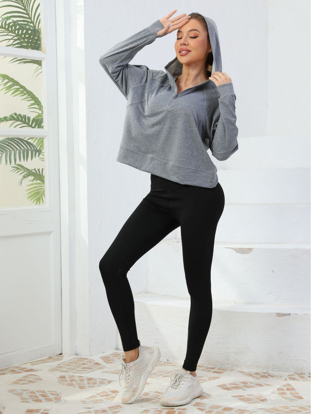 Gray half-zip cotton hoodie sweatshirt with drawstring hood and long sleeves
