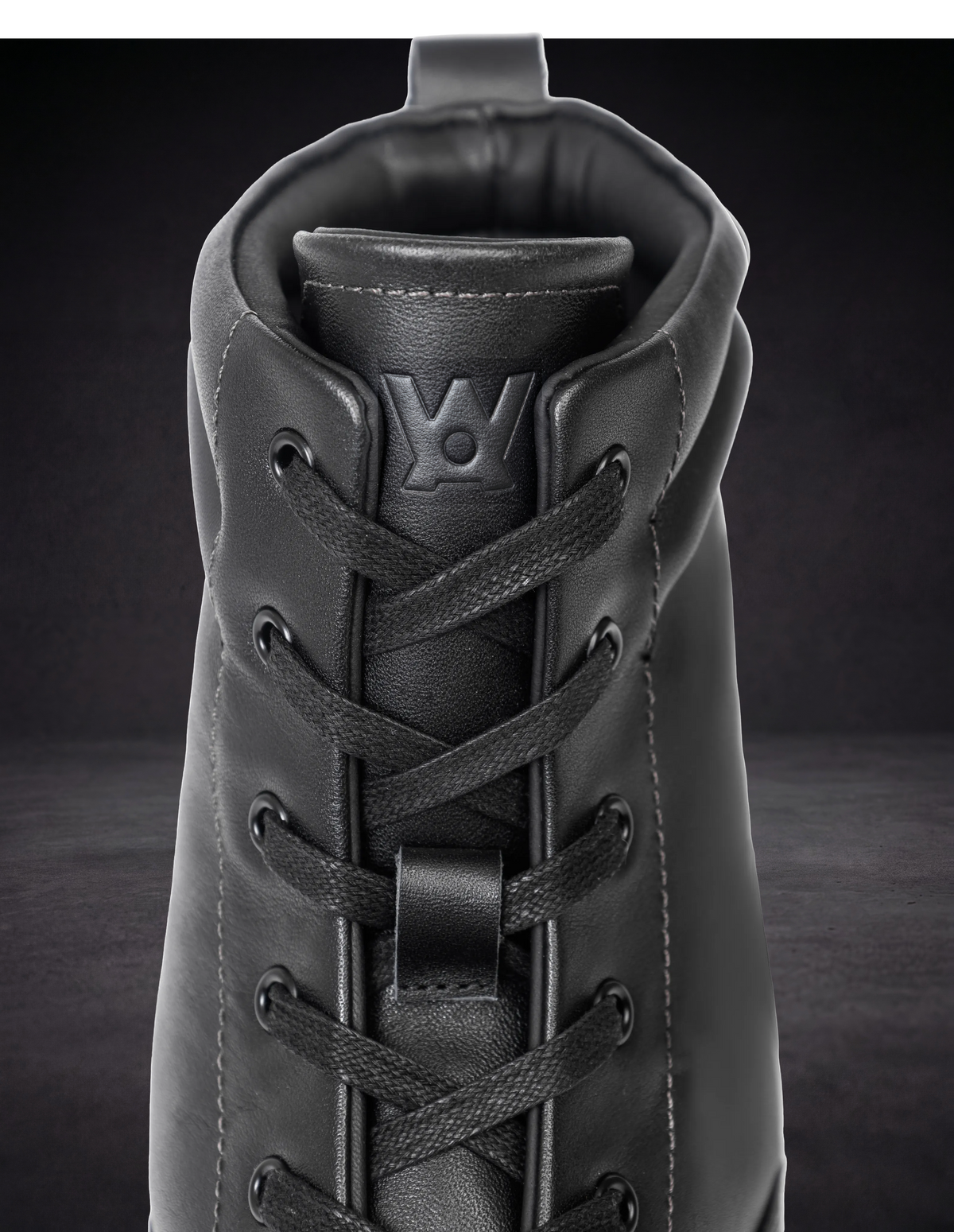 WOA lace-up boot front with woven laces and padded tongue opening