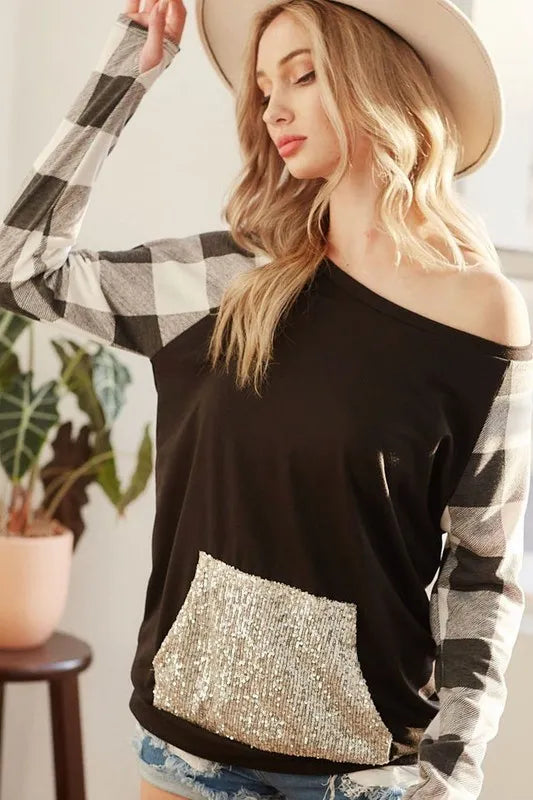 Black off-shoulder French terry top with check sleeves and gold sequin kangaroo pocket