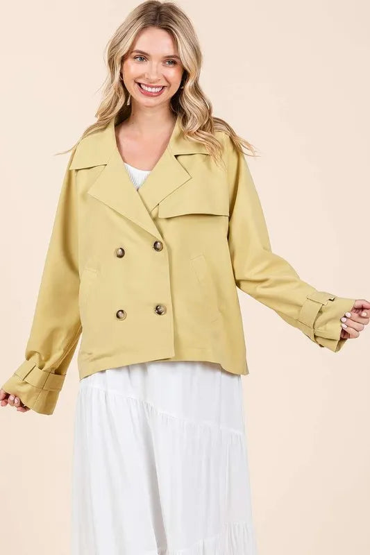 Yellow trench coat jacket with long sleeves, double buttons, and flap pockets