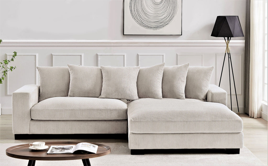 L-shaped sectional sofa with chaise, light beige corded upholstery and matching cushions