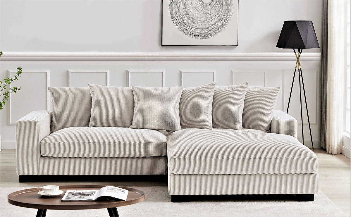 L-shaped sectional sofa with chaise, light beige corded upholstery and matching cushions