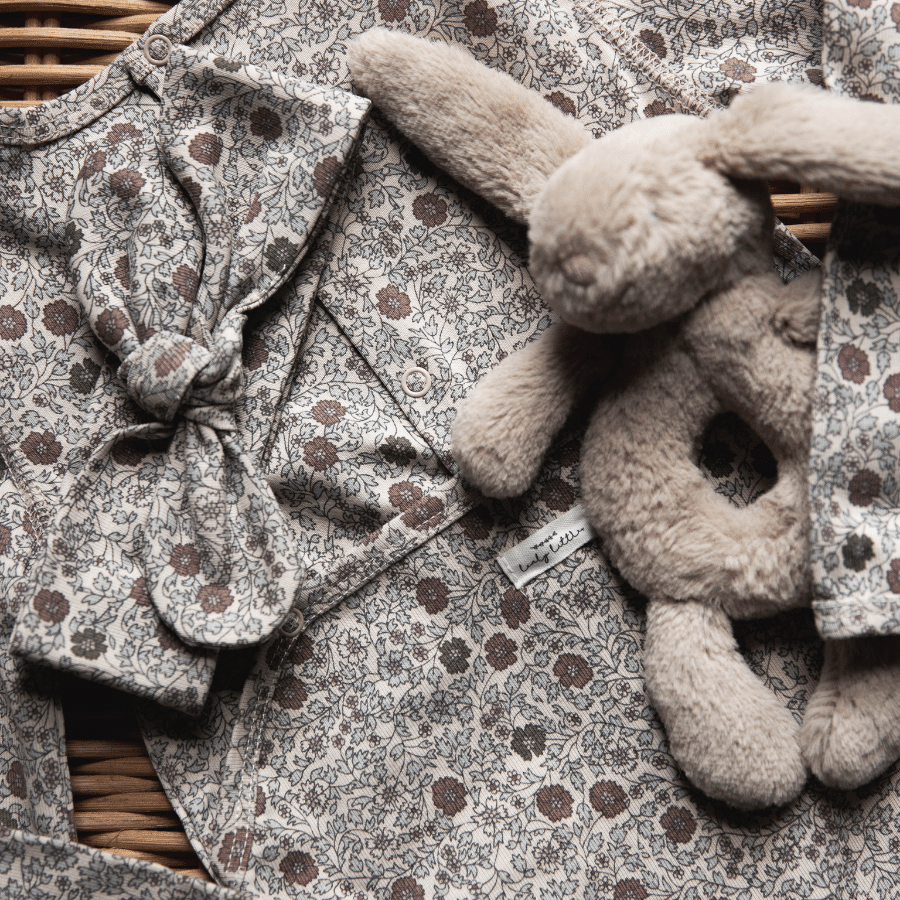 Baby hooded jacket close-up, floral print outer with fuzzy sherpa trim at hood