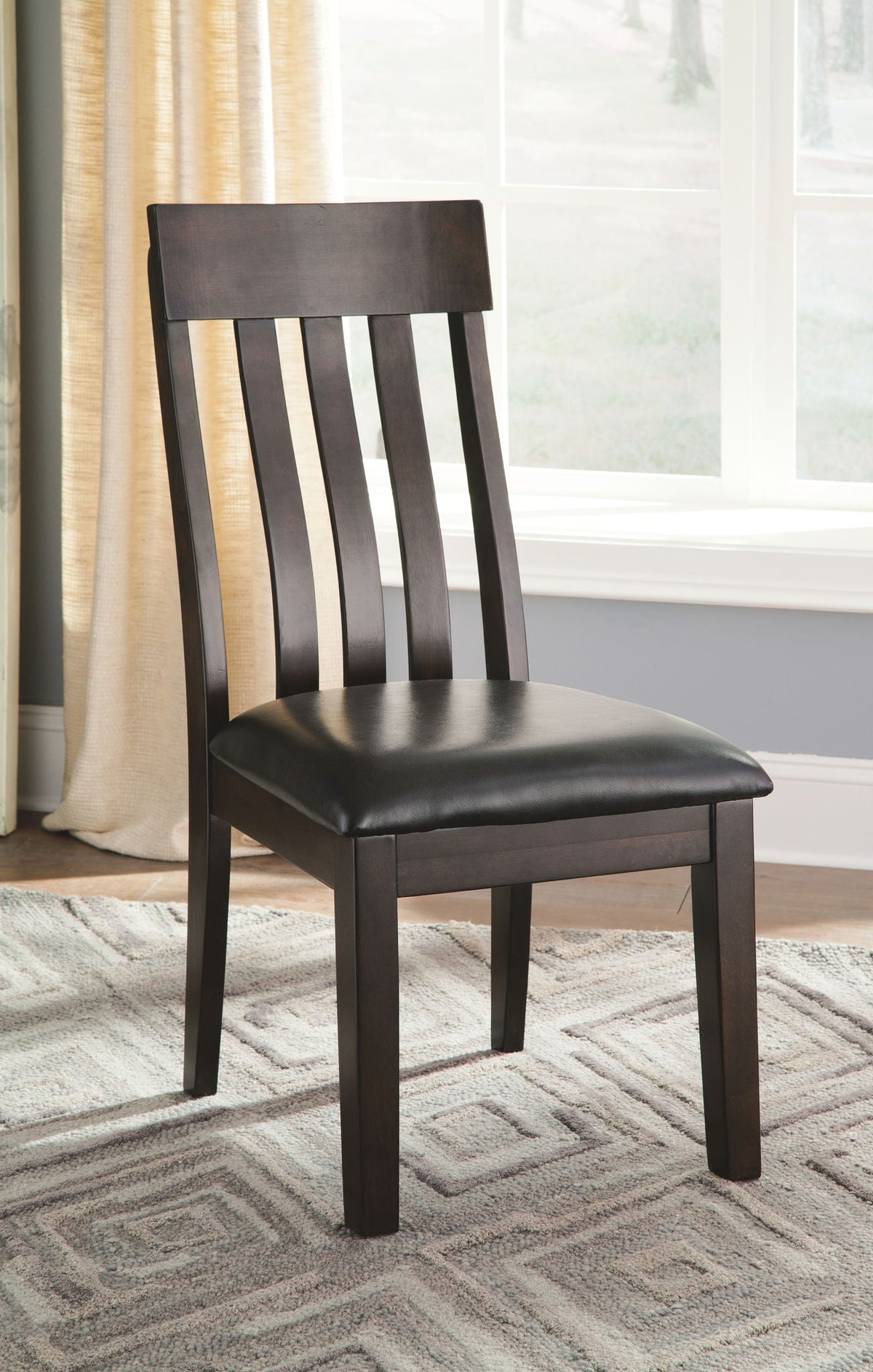 Single dark brown dining side chair with slatted back and black upholstered seat