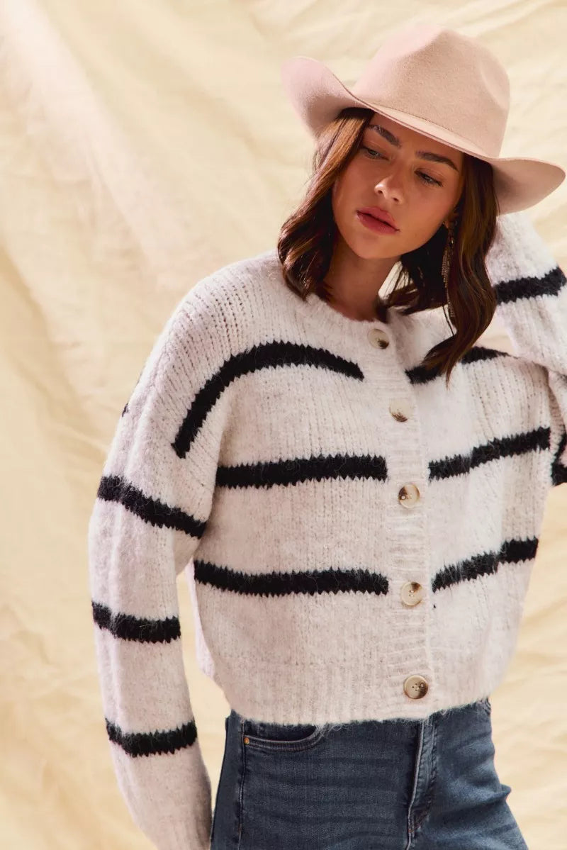 Cream and black striped button cardigan with long sleeves and ribbed knit cuffs