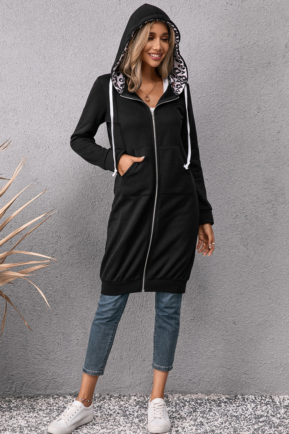 Black drawstring hoodie dress with leopard hood lining, front zipper, side pockets