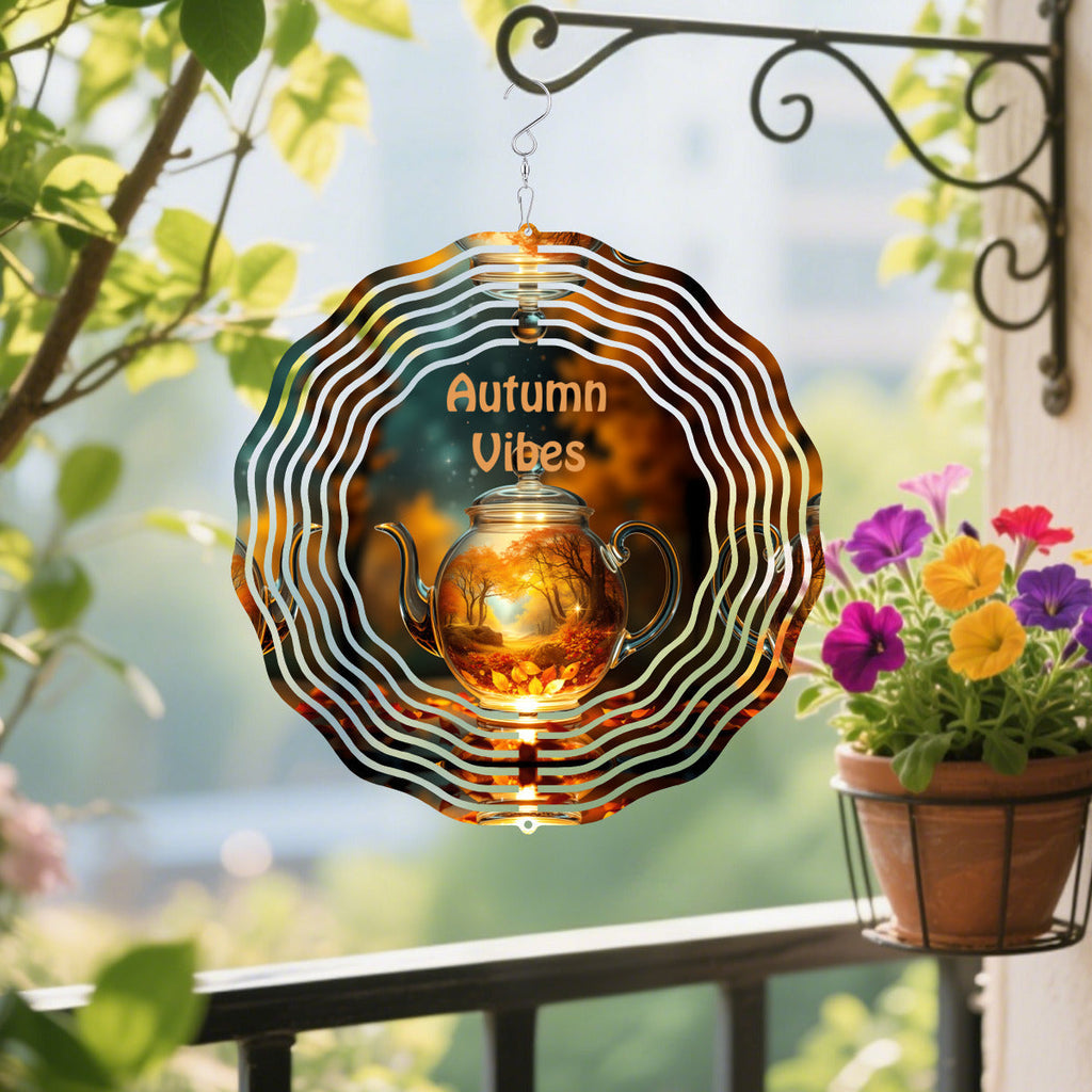 Brown circular wind spinner with hanging teapot ornament and spiral striped ring