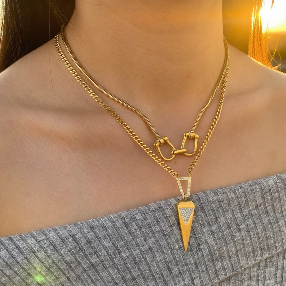 Gold layered horse bit necklace with triangular pendant on rope chain