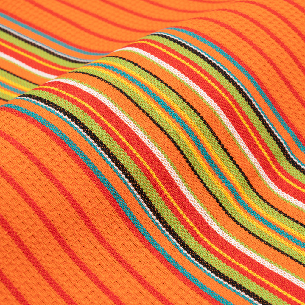 Close-up of orange kitchen towel with multicolor striped weave
