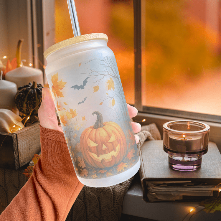 Frosted glass iced coffee tumbler with lid, straw, and pumpkin and bats graphic