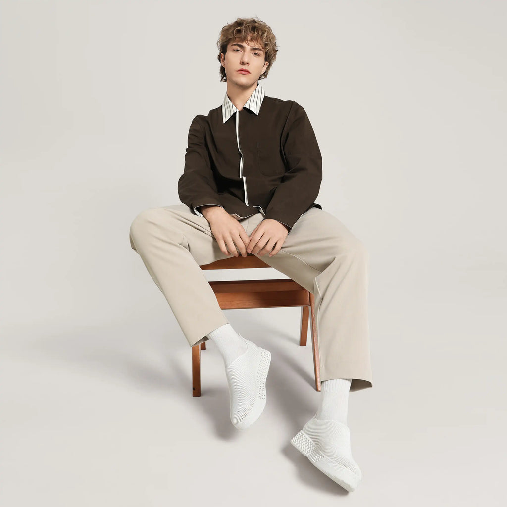 White 3D-printed slip-on sneakers with ribbed knit upper, on model in light socks