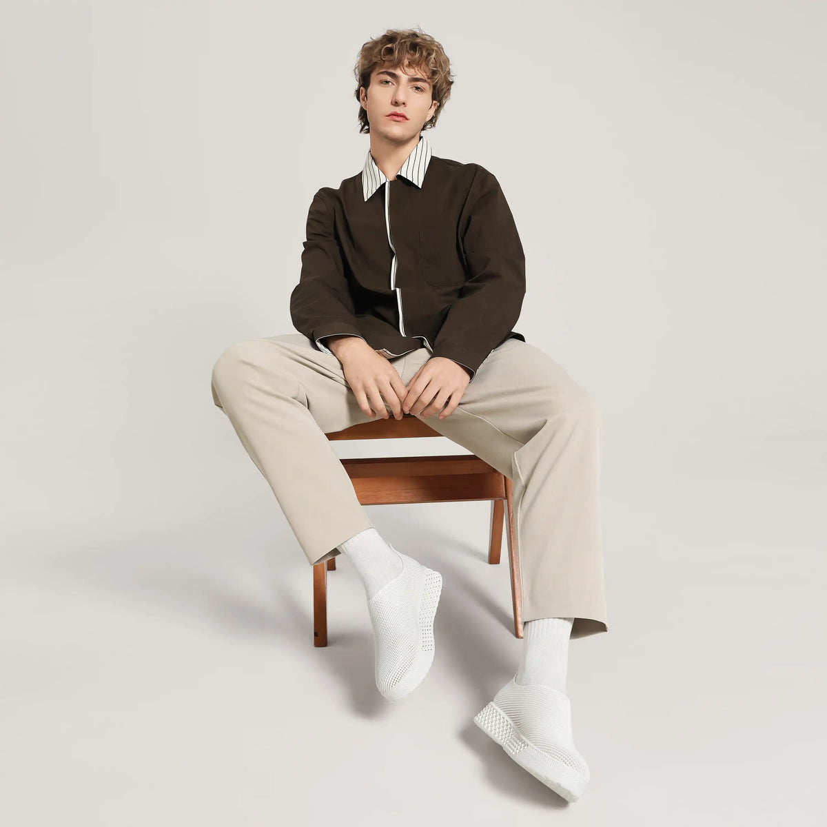 White 3D-printed slip-on sneakers with ribbed knit upper, on model in light socks