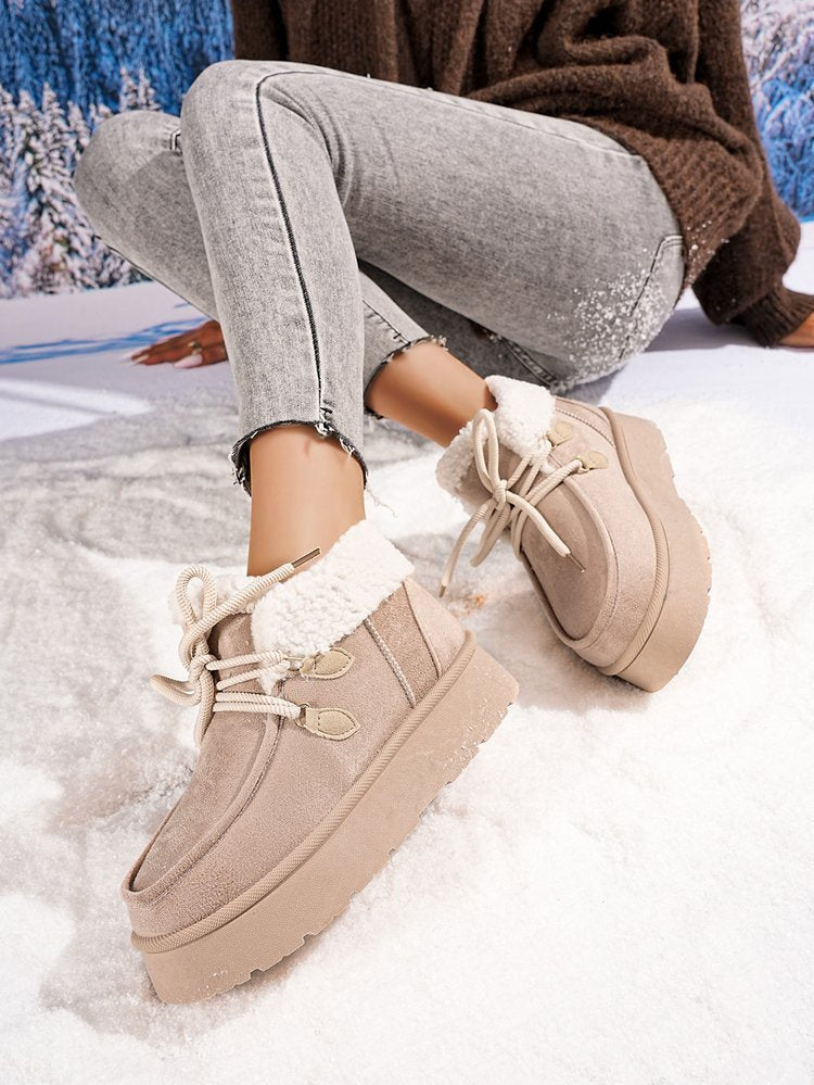 Beige fleece-lined snow boots with lace-up top, sherpa trim, and thick platform sole
