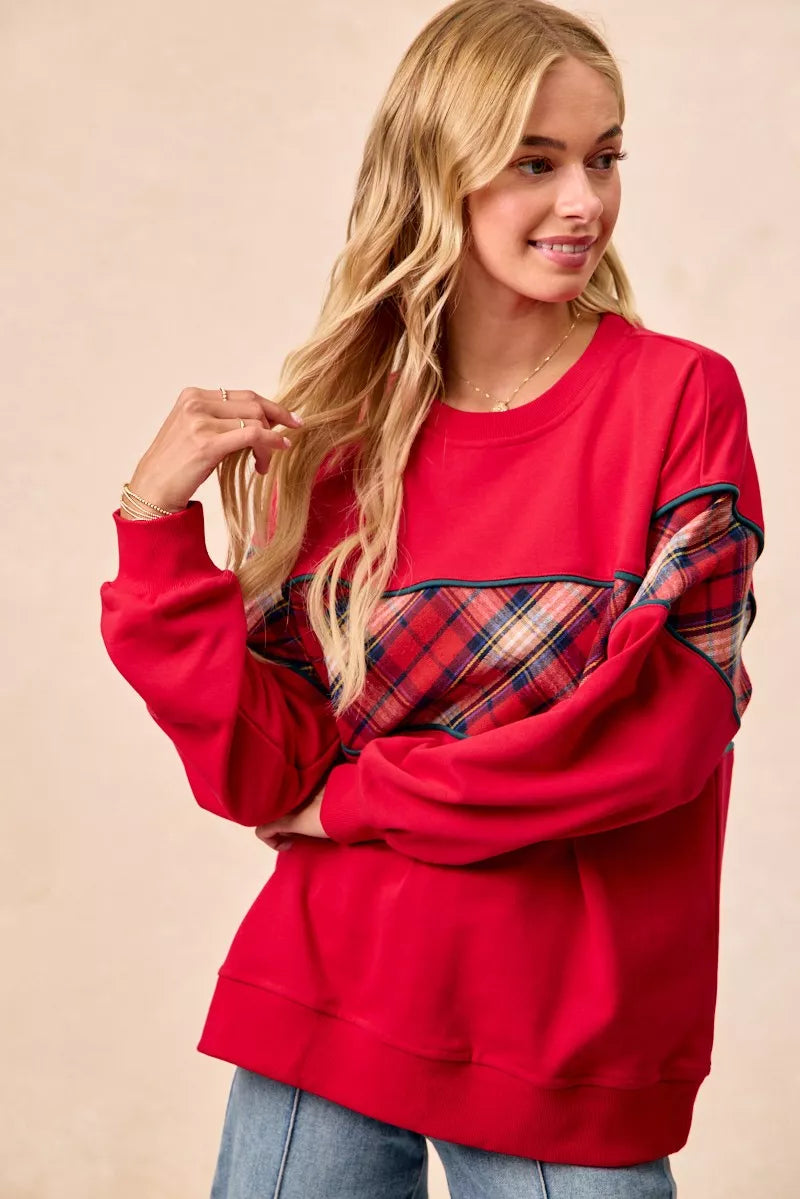 Red sweatshirt with plaid center panel and teal edging, crew neck, ribbed cuffs