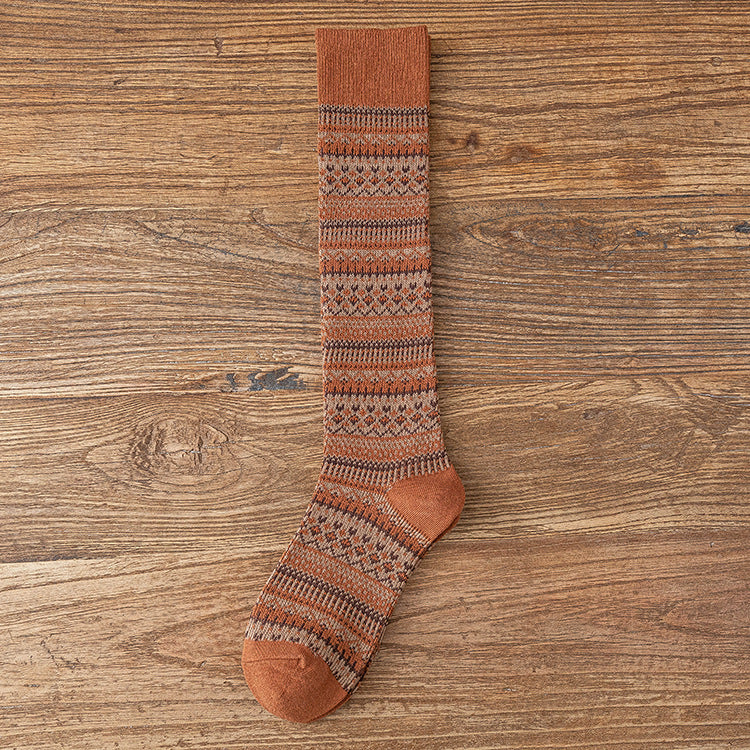 Children’s knee-length socks in rust brown with multicolor striped knit and matching toe.