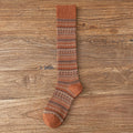 Children’s knee-length socks in rust brown with multicolor striped knit and matching toe.