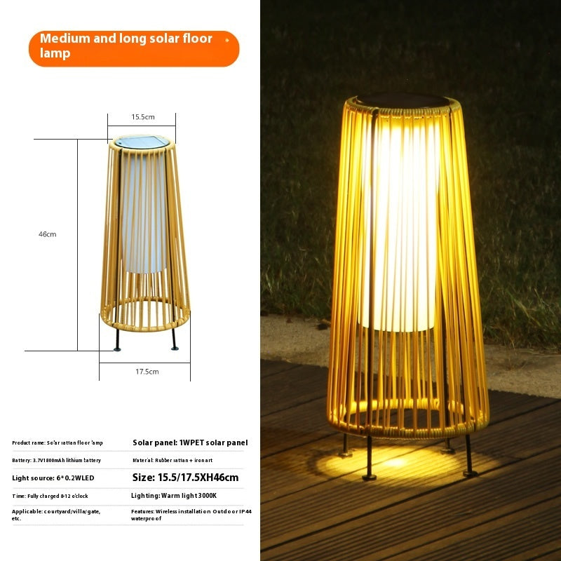 Solar floor lantern with gold vertical ridged shade, warm light glowing on base