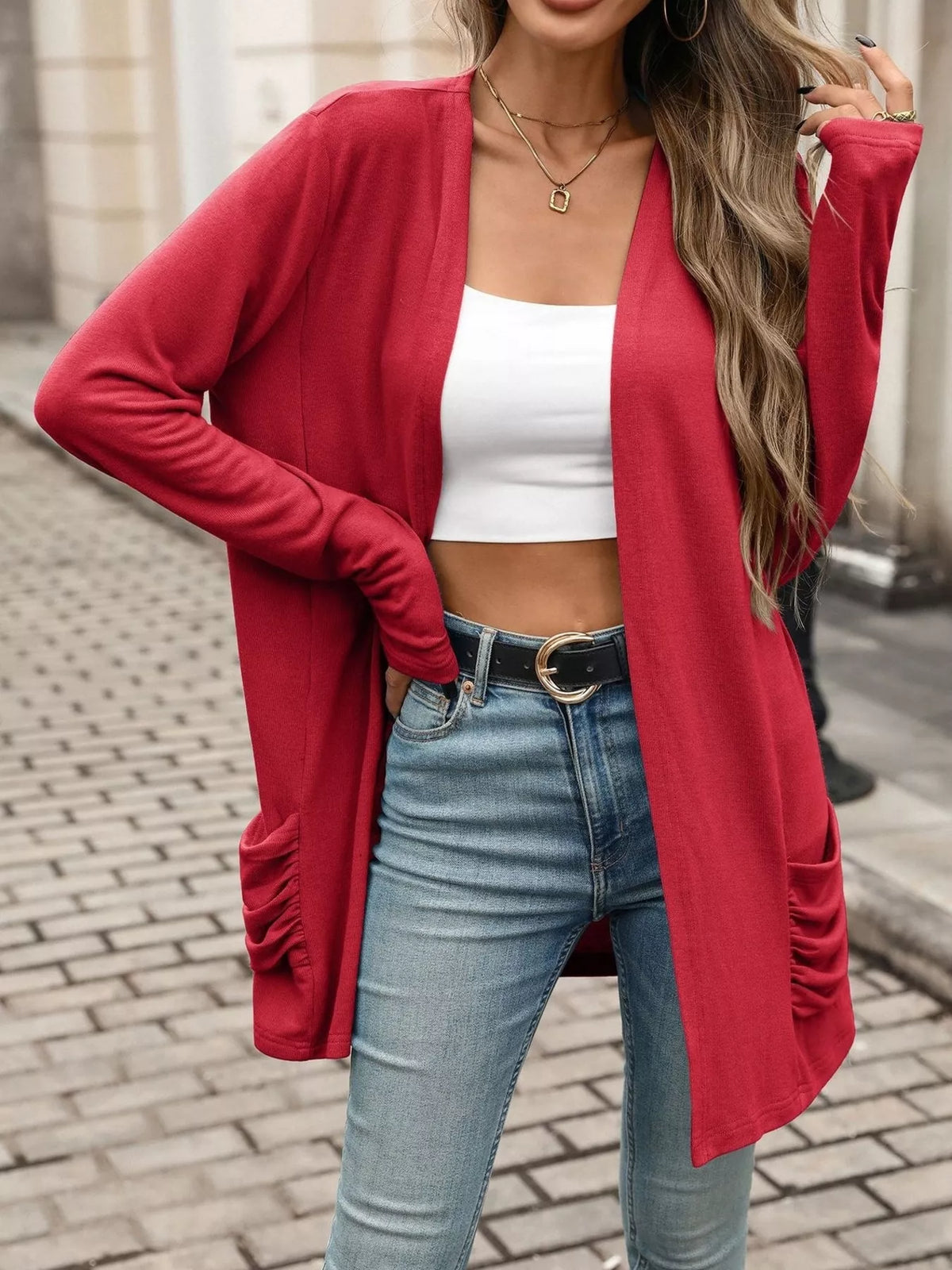 Red open-front cardigan with ruched side pockets and long sleeves, draped fit