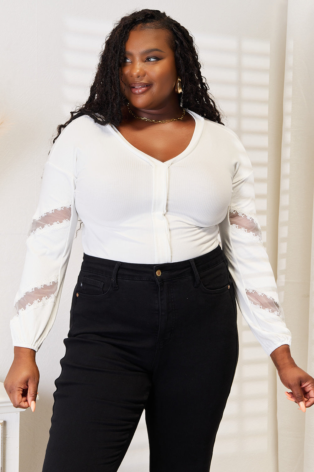 White v-neck blouse with button-front closure and lace sleeves, front view