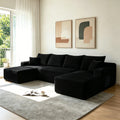 Black U-shaped sectional sofa with chaise, deep cushions and multiple throw pillows