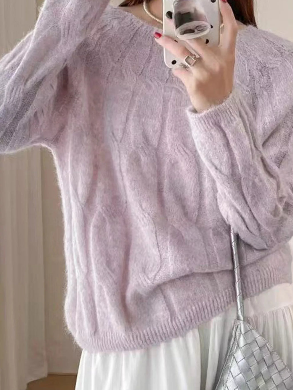 Pink cable-knit round neck sweater with long sleeves and ribbed hem