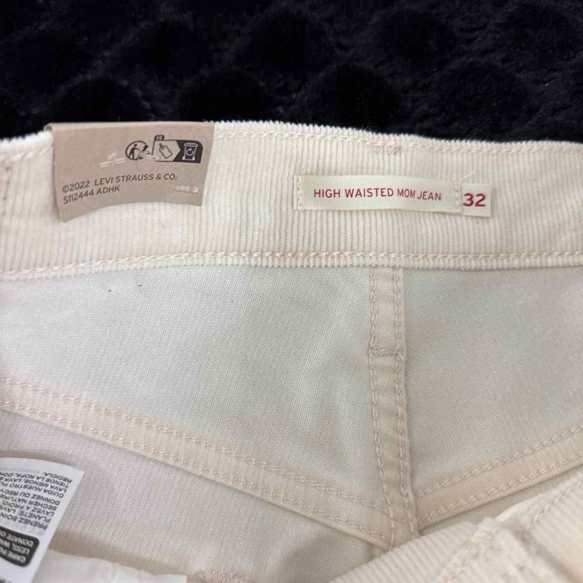Cream jeans waistband label showing high waisted mom jean and size 32