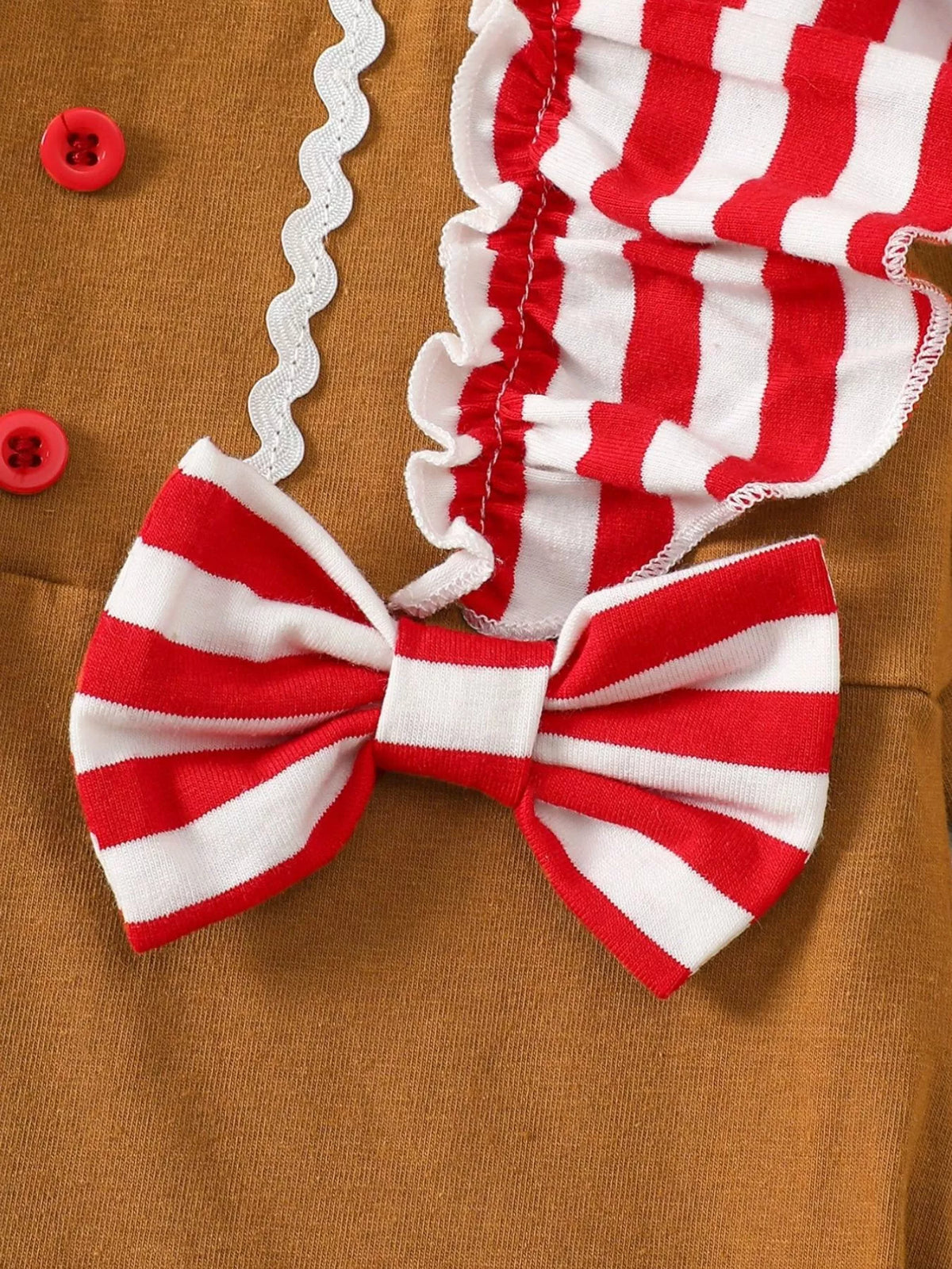 Caramel jumpsuit with red-and-white striped bow and ruffled button front
