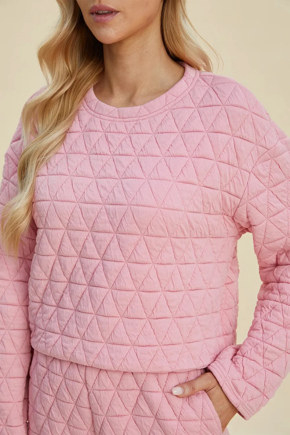 Pink quilted-look textured long-sleeve top with crew neckline
