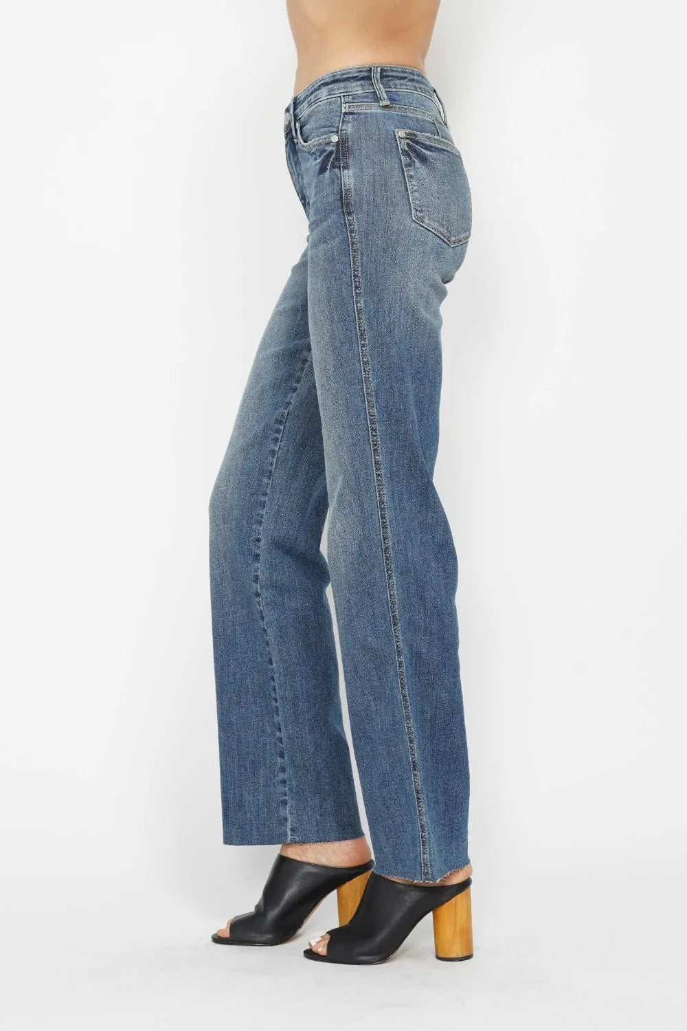 Medium-wash straight-leg jeans, side view with five-pocket styling