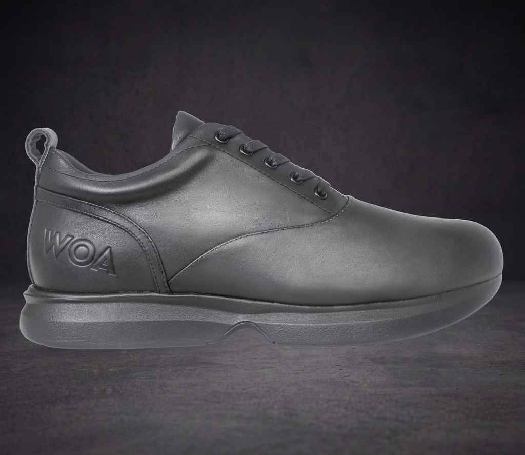 WOA low-top dress sneaker in dark leather, lace-up with WOA logo on side