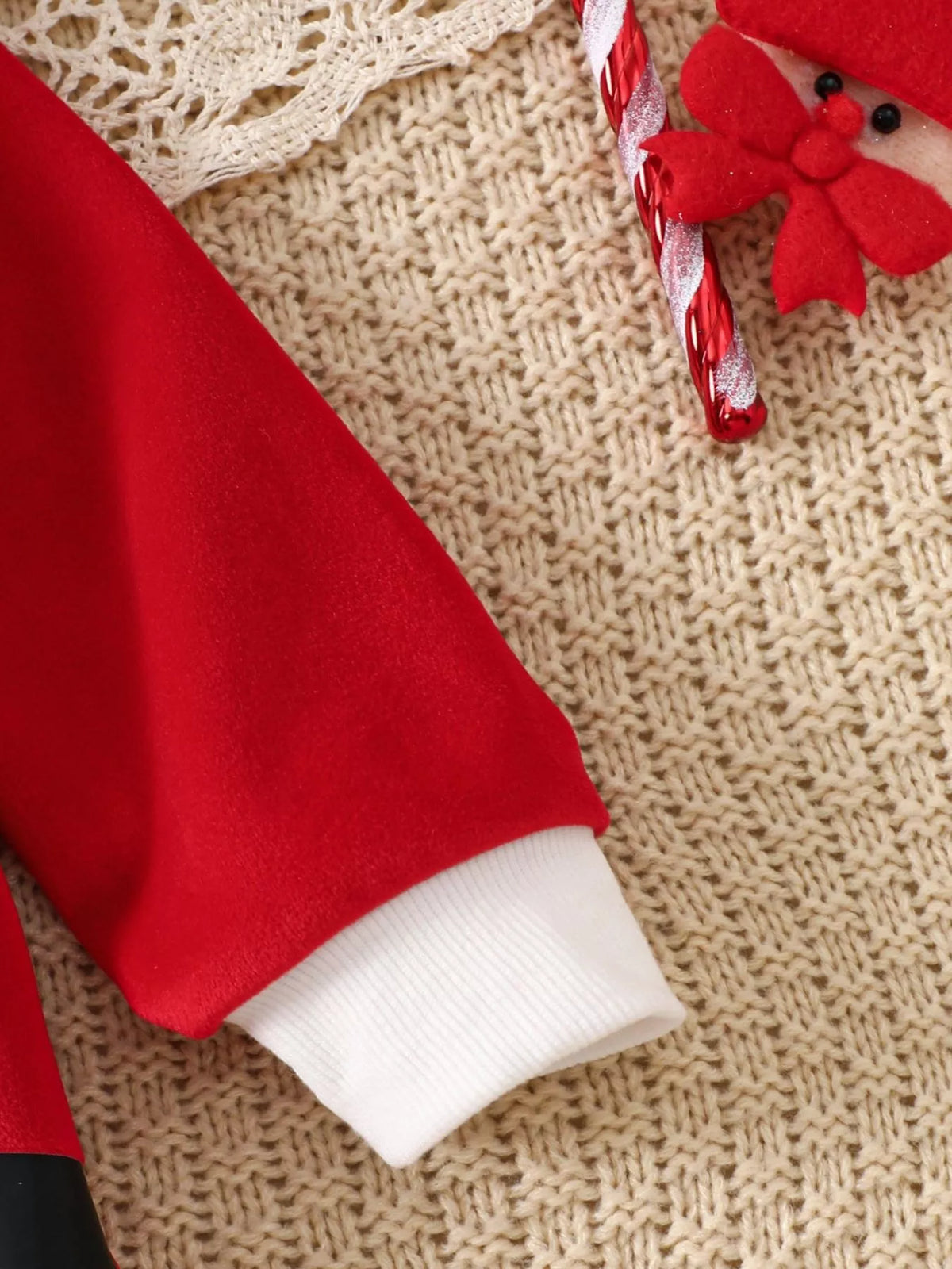 Children’s red Santa one-piece sleeve with white cuff hem and soft fur trim