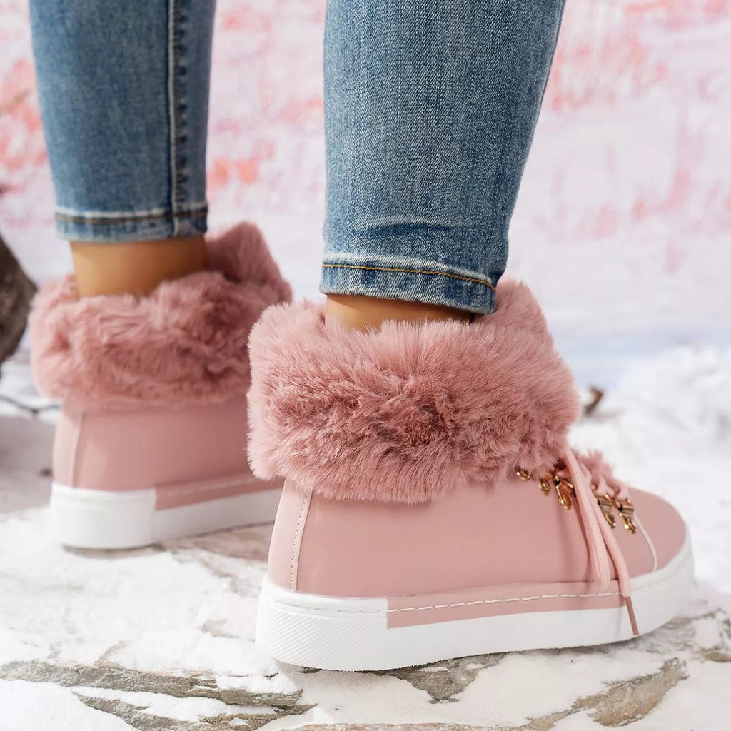 Pink lace-up ankle boots with plush fuzzy cuff and gold hardware