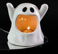 Ceramic ghost candle ornament with lit tea light, white body and glowing orange inner cavity
