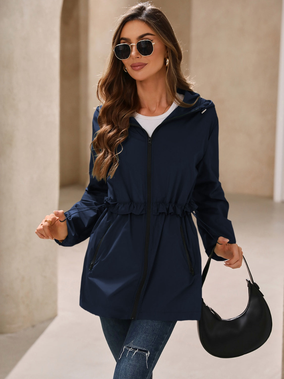 Navy hooded windbreaker jacket with zip closure and gathered waist, front view