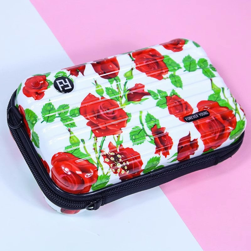 Cosmetic bag with red rose and green leaf print on white, zip top