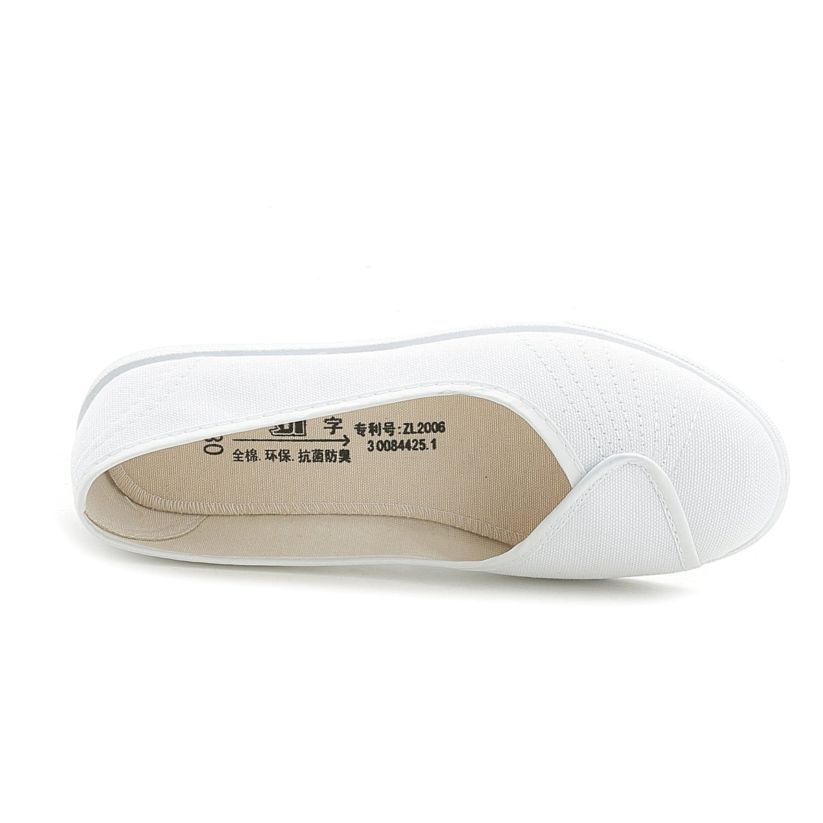 White slip-on sneakers showing beige interior lining
