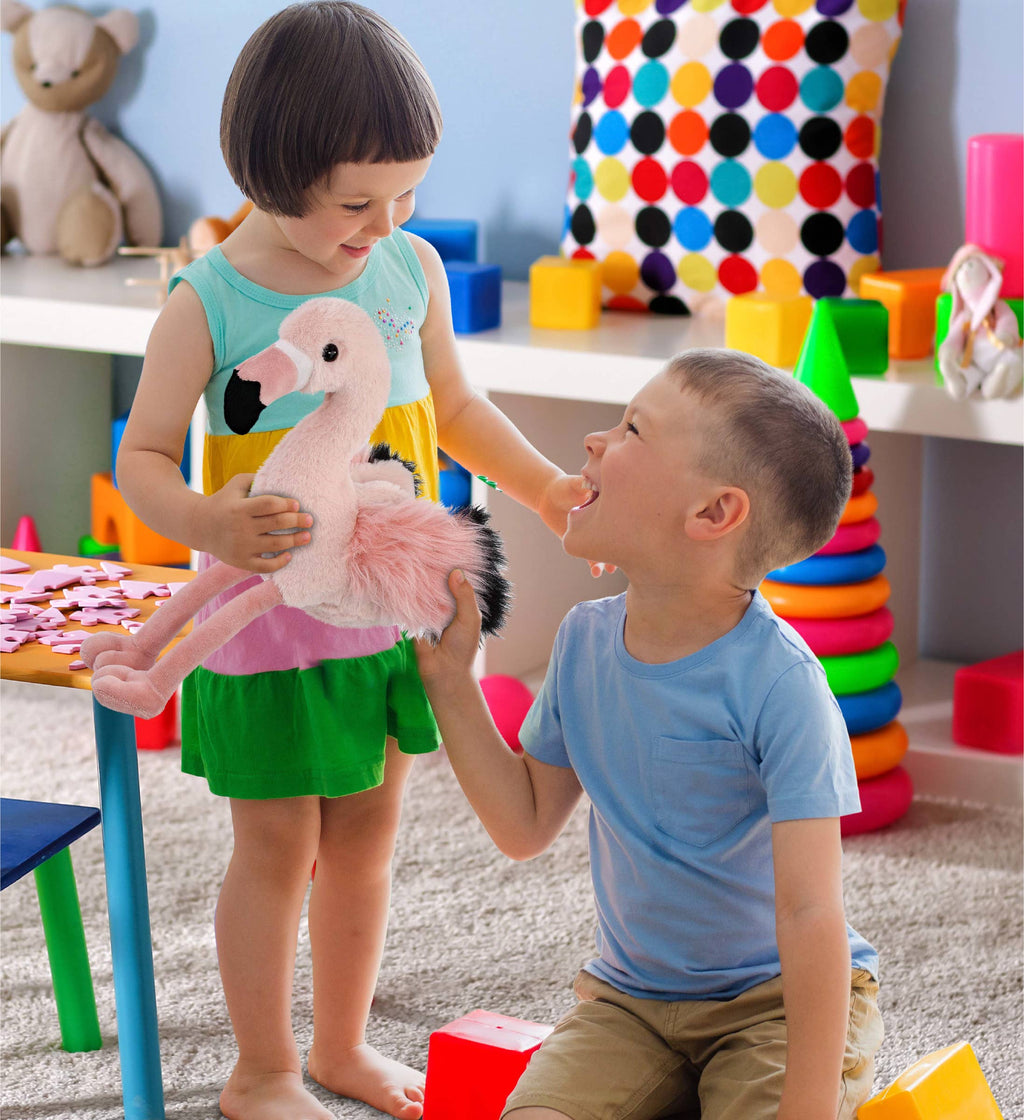 Light-pink flamingo plush toy with black beak and long legs, held during play