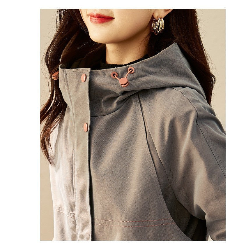 Women's smoky gray windbreaker coat close-up, hood with drawstring, buttoned front placket