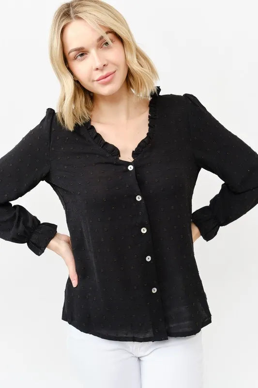 Black polka-dot blouse with ruffle collar, button front, and long cuffed sleeves