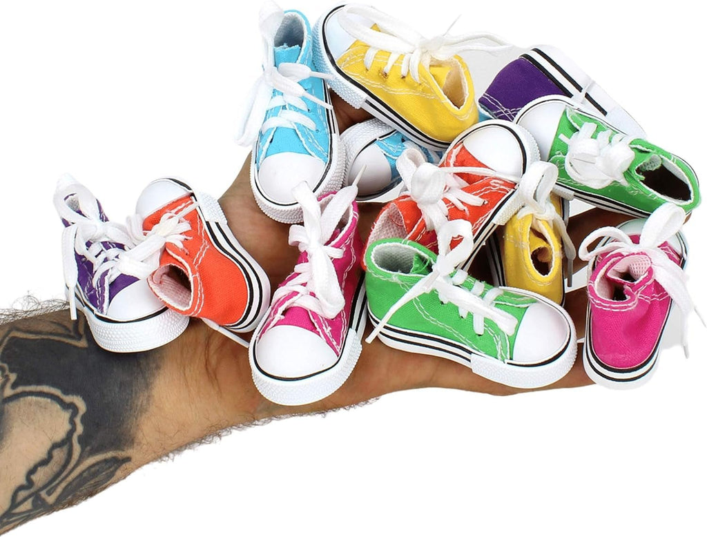 Assorted mini bird sneakers resting in a person's hand