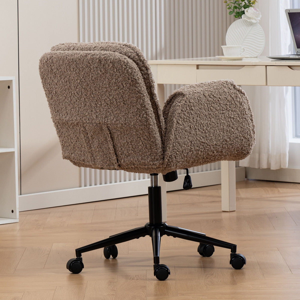 Dark brown fabric swivel desk chair with padded armrests and rolling casters on base.